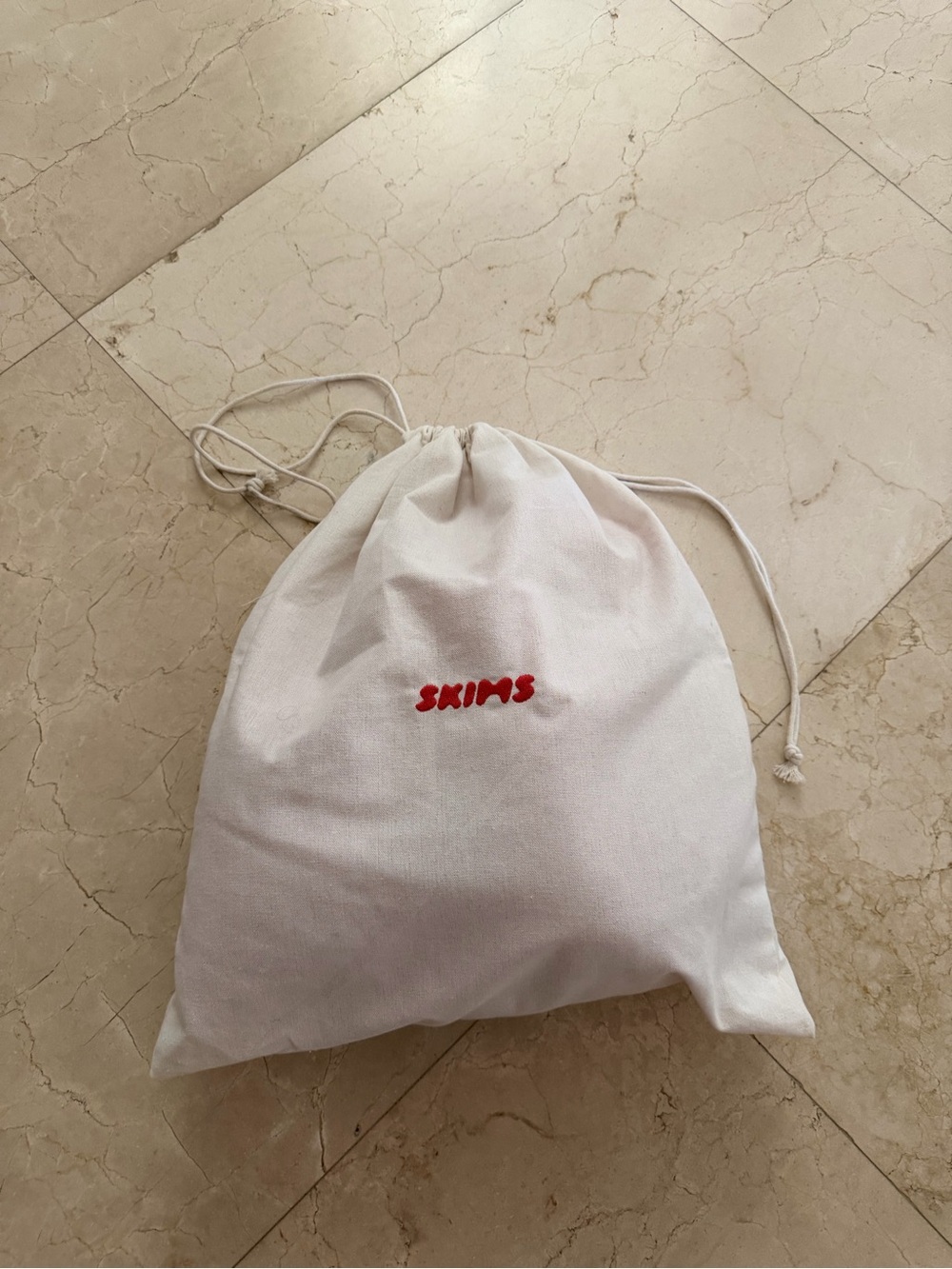SKIMS faux fur heart slippers with drawstring dust bag with red logo